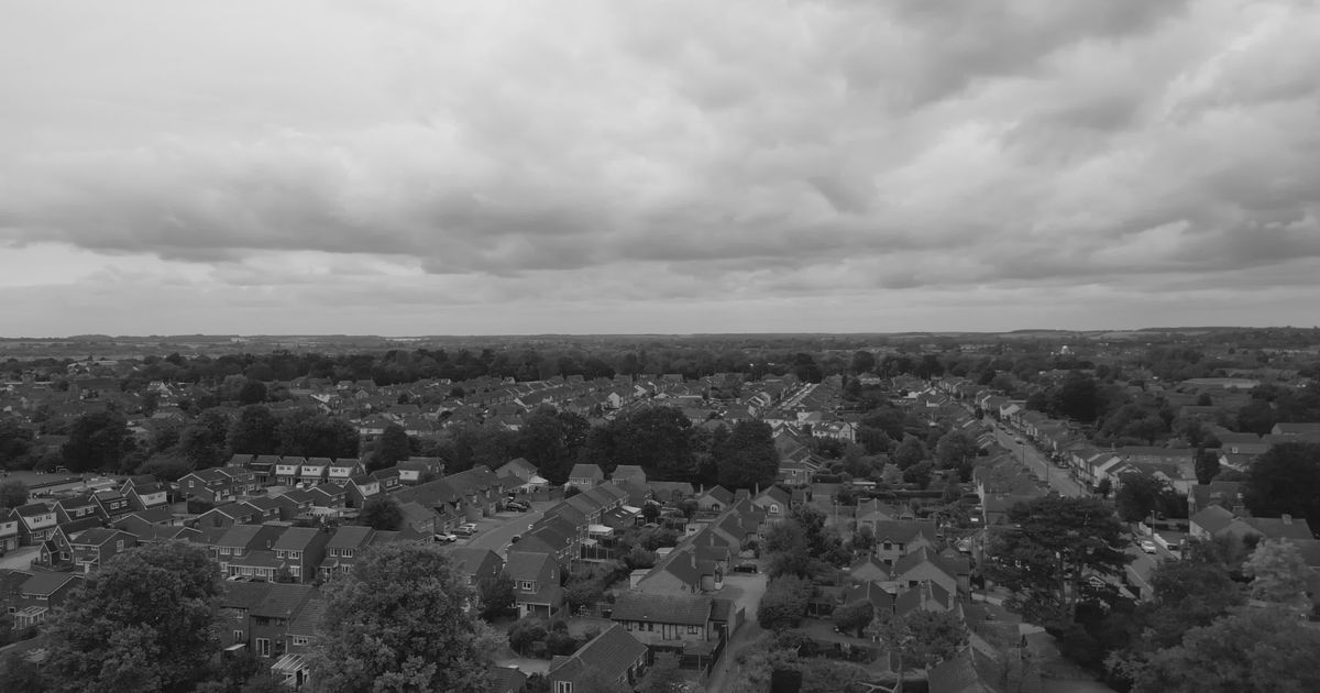 dramatic aerial shot of suburban homes under cloudy skies 31303944 — free pexels stock footage