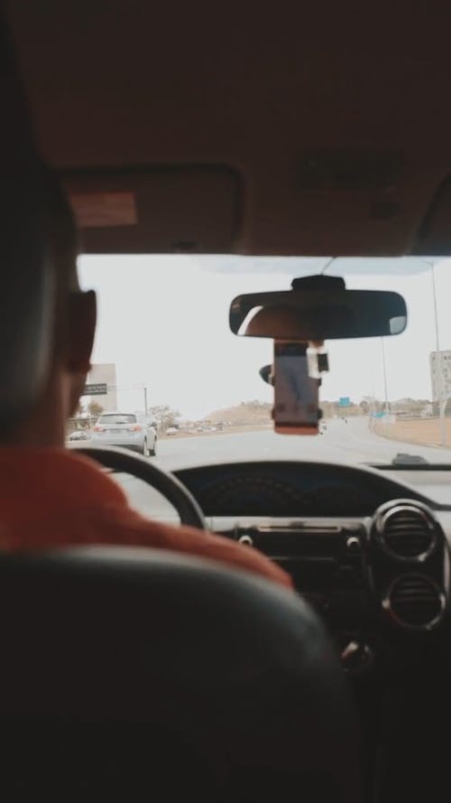 Man Driving Using Maps on the Phone