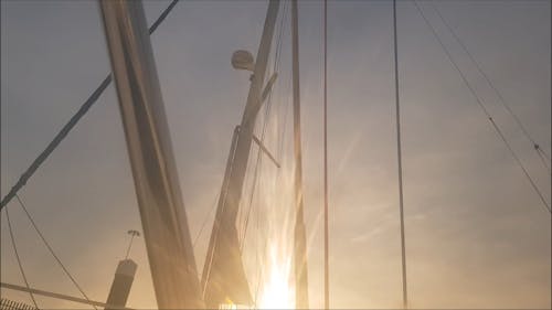 A Sailboat Masts With Sail Curtain Down