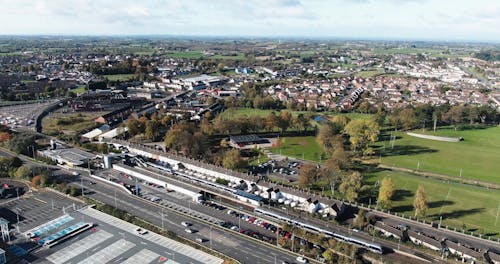 A Train Stopping On A Station In An Urban Community