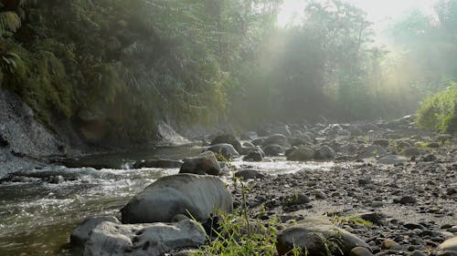 A Rocky River With Rays Of Sunlight
