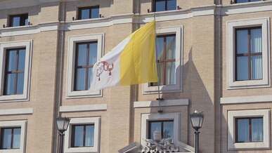 vatican flag waving on building exterior