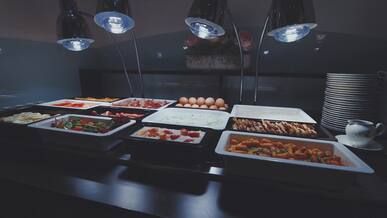 buffet table with assorted dishes under warm lighting
