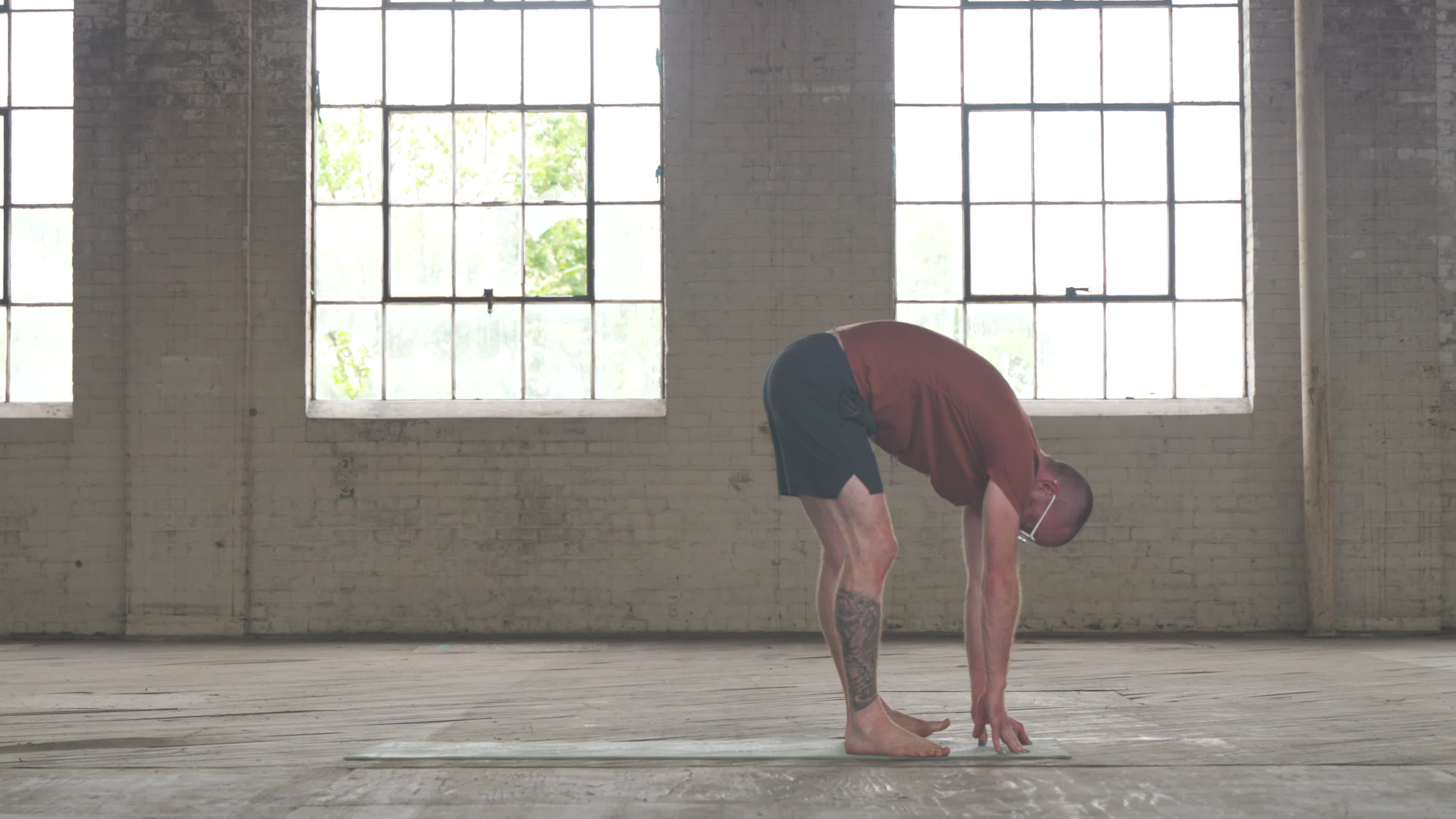 A person practicing yoga in a sunlit room