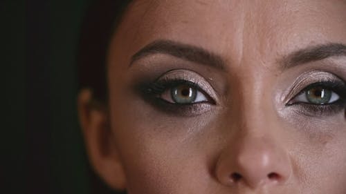 A Woman Applying Makeup Shadows Around Her Eye