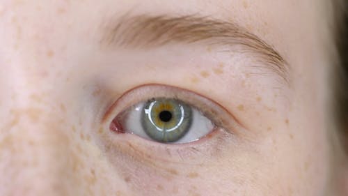 A Woman Putting On A mascara On Her Eyelashes