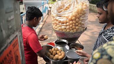street vendor selling indian pani puri snacks