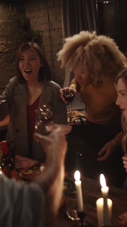 People In A Party Raise Their Glasses Of Wine For A Toss