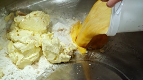 Pouring Scrambled Eggs On A Mixer Combining With Flour And Butter