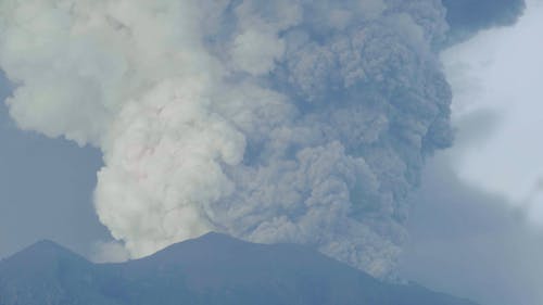 An Erupting Volcano Spewing Volcanic Ash Up In The Air