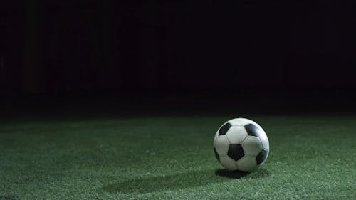 A Person Kicking A Soccer Ball 