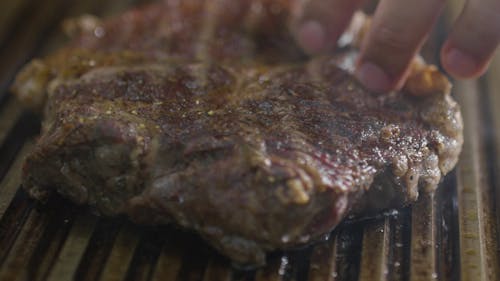 Close-Up View Of Meat Being Grilled 