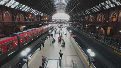 busy urban train station with red trains