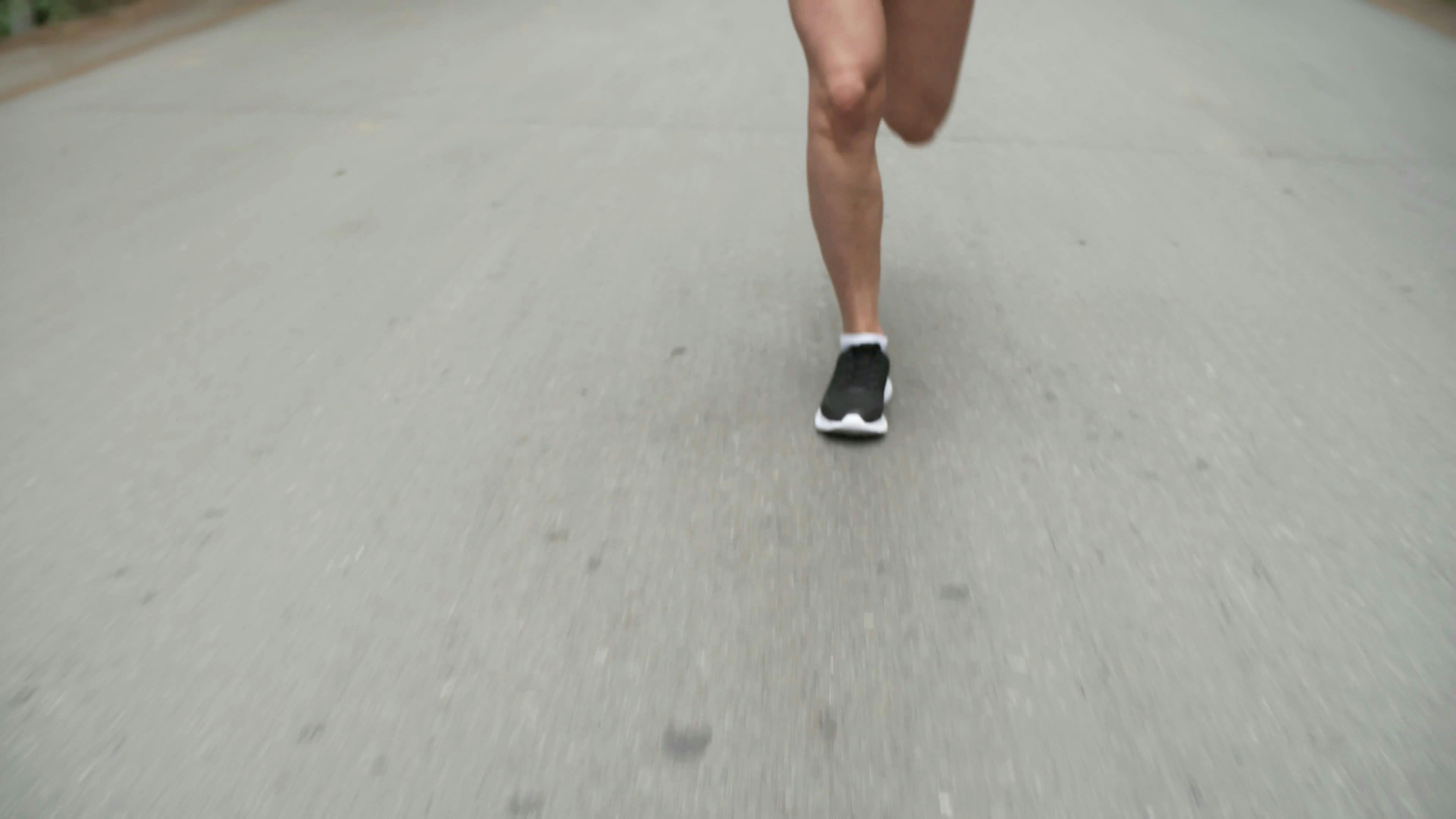 A Woman Running On A Concrete Pavement · Free Stock Video