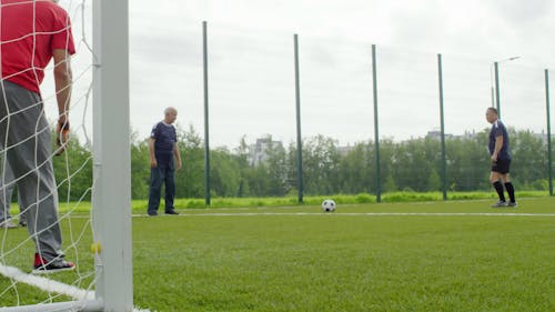 Group Of Elderly Men Playing A Game Of Soccer