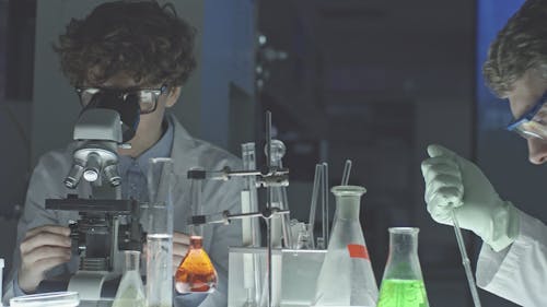 A Man And A Woman Doing Scientific Work Inside A Laboratory