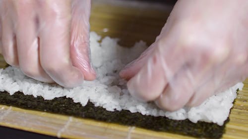 Person Making A Sushi Roll