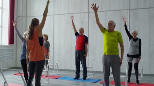 Am Instructor Showing A Group Of Elderly People Some Bending Exercise