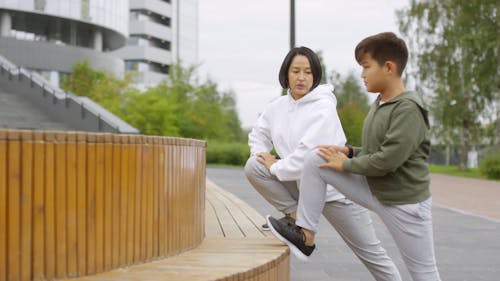 A Woman Teaching A Leg Stretching Exercise