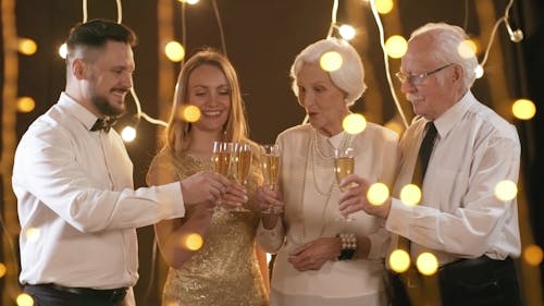 Two Couples Tossing Their Glasses Of Wine