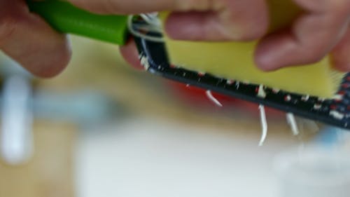 Grating A Block Of Cheese Using A Grater