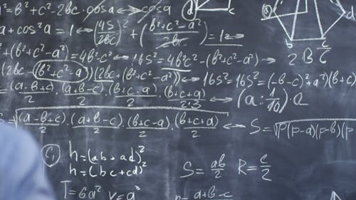 Woman Writing Equations On A Blackboard