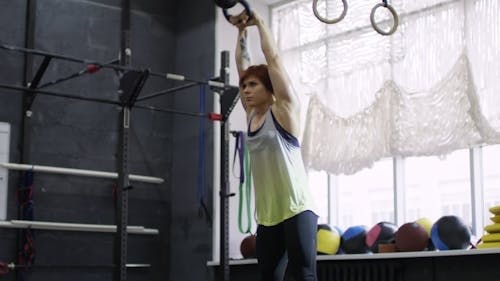 Woman Doing Lifting Exercises In A Gym