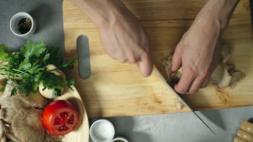 A Person Slicing Mushrooms