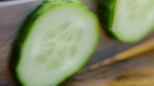 Person Slicing A Cucumber