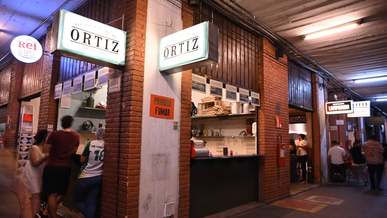 people buying food on the counters of fast food stalls