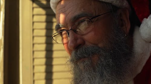 Close-up Of An Elderly Man Face Dressed As Santa Claus