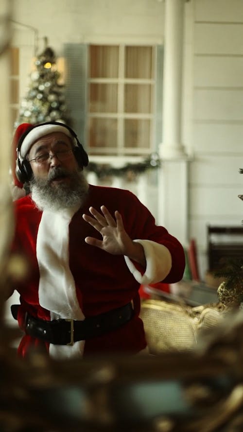 Santa Claus Dancing To A Music On His Headphone