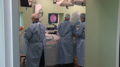 Doctors Working On A Surgery In The Operating Room