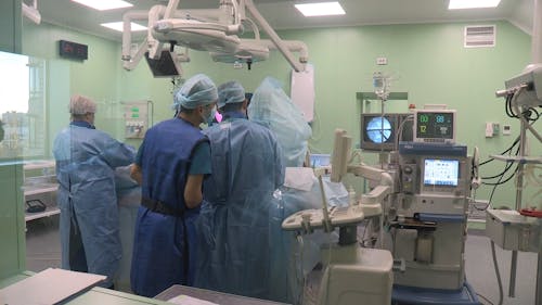 Group Of People In A Medical Field Inside An Operating Room