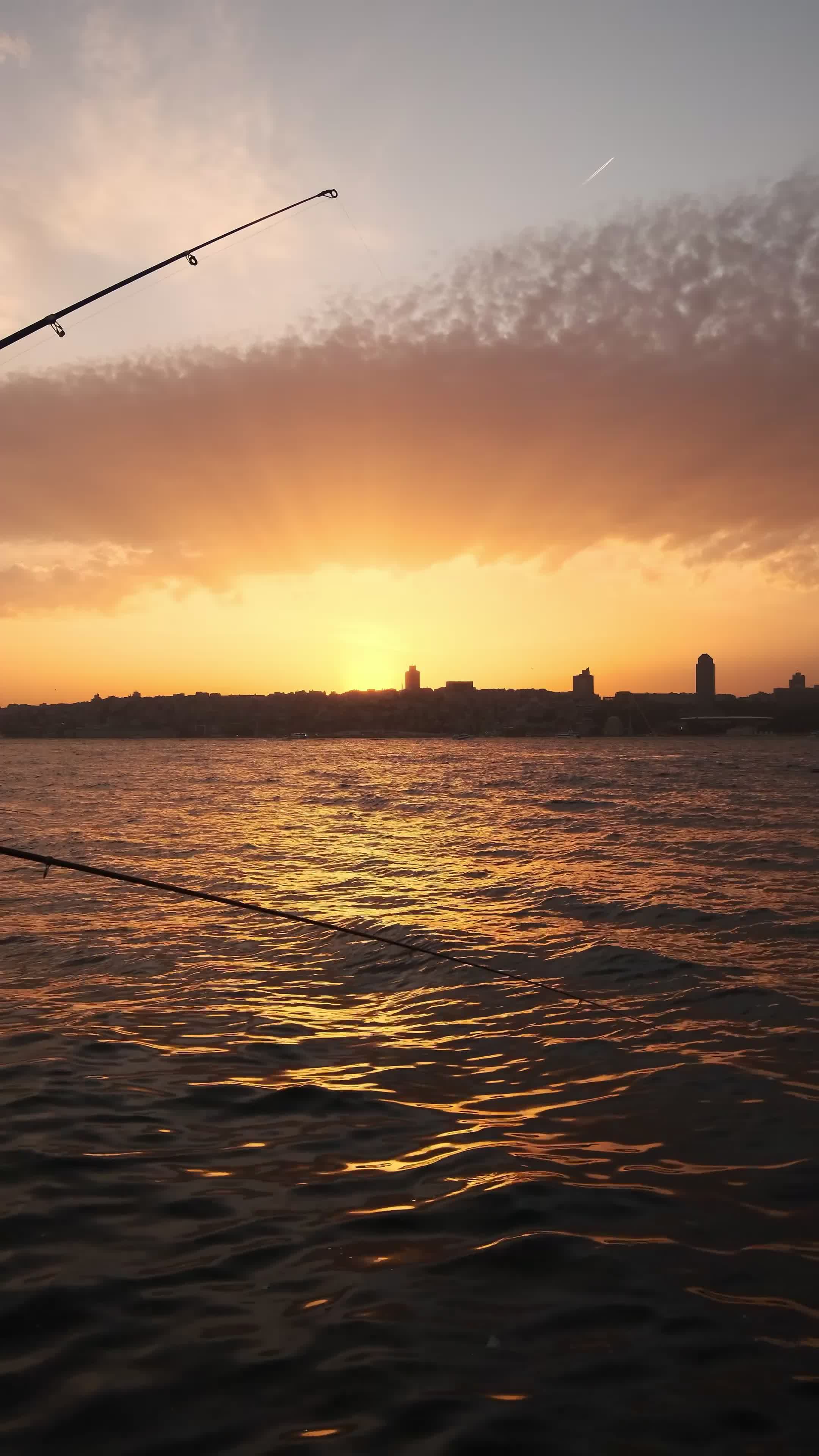 Serene Sunset Fishing Over City Waters Free Stock Video Footage ...