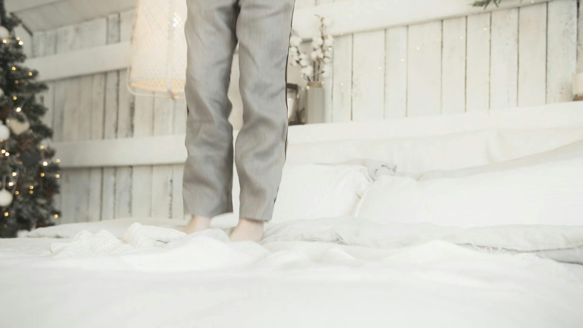 A Kid Jumping Up And Down In A Bed Free Stock Video