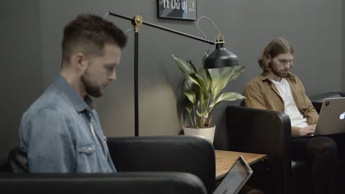 Two Men Working With Their Laptops