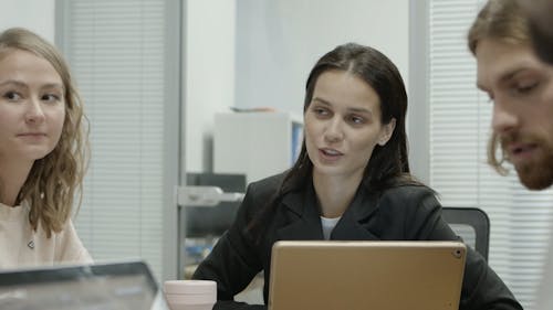 People In A Business Meeting Passing A Piece Of Document