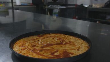 preparing delicious cheese pizza in kitchen