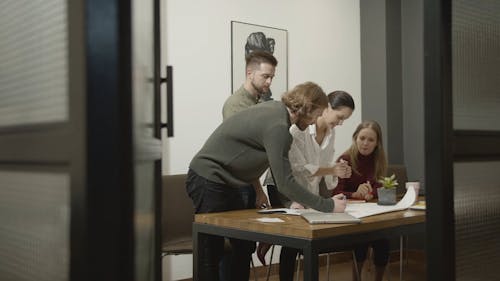 People Working And Discussing On A Project