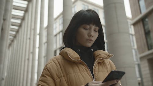 Portrait Of A Standing Woman Using A Cellphone