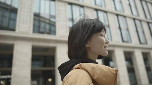 Woman Walking On The Street Outside A Building