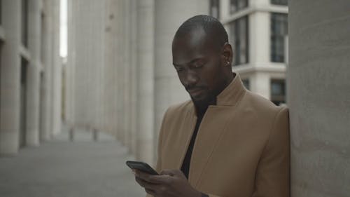 Man Standing Outside A Building Having Conversation Over The Phone