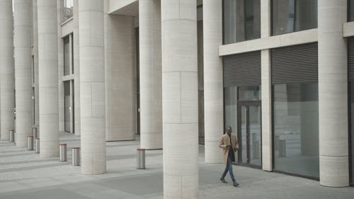 Man Walking Outside A Building 