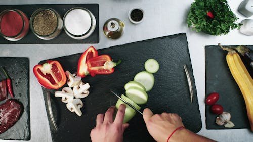 Cutting Vegetables To Pieces In A Chopping Board