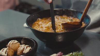 savoring delicious ramen noodles with takoyaki