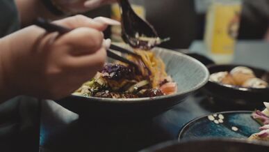 chopsticks eating noodles at a cozy restaurant