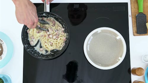 A Man Preparing Creamy Pasta For Food