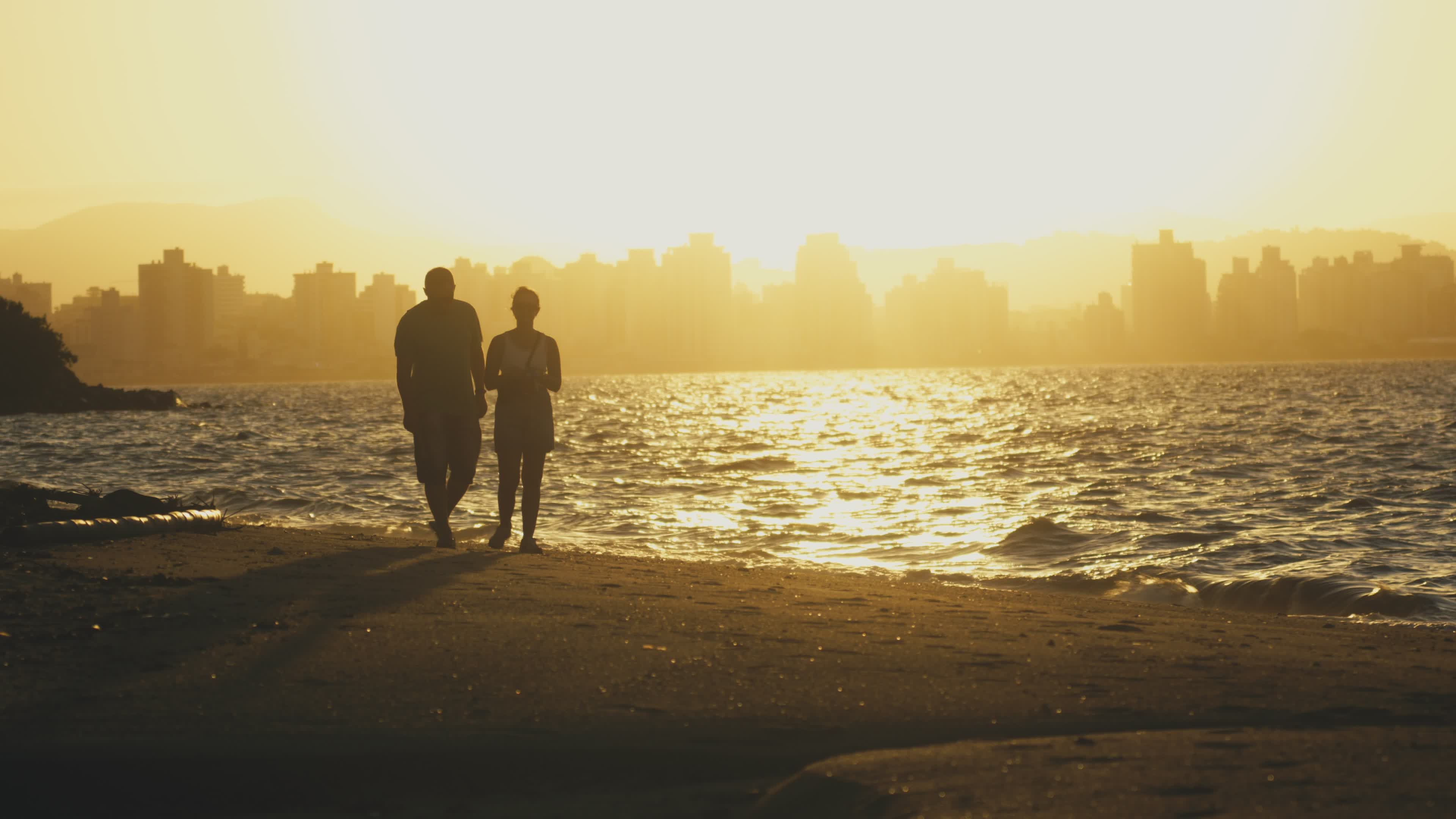 Romantic Beach Walk at Sunset with Cityscape Free Stock Video Footage ...