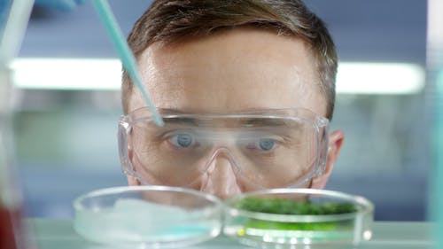 A Man In Deep Focus Of His Observation In An Experiment Being Undertaken